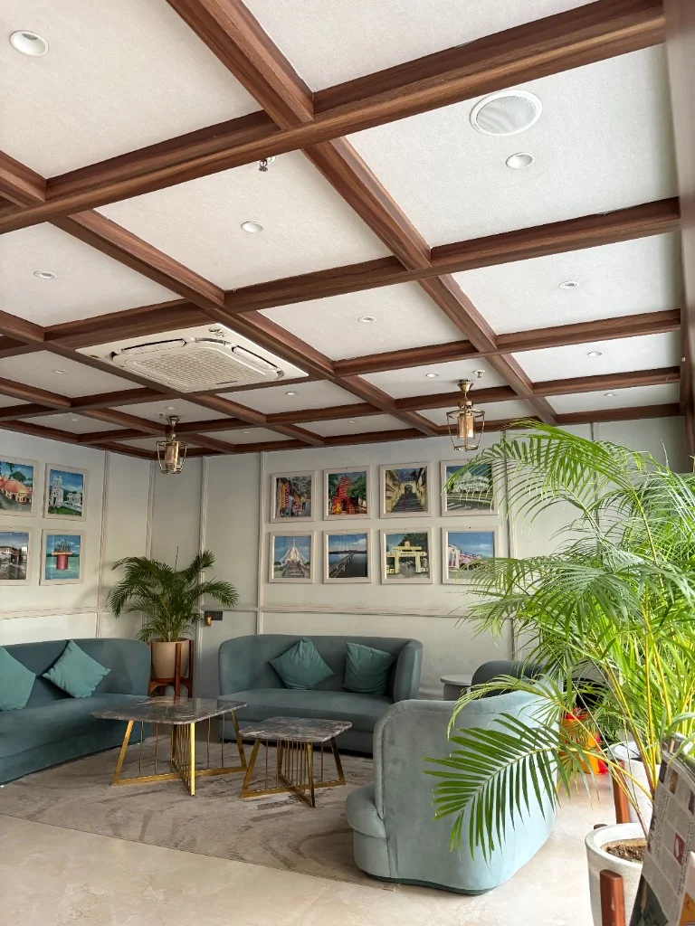 Lounge gallery at Lakasii with soft seating, marble tables and a coffered wood ceiling